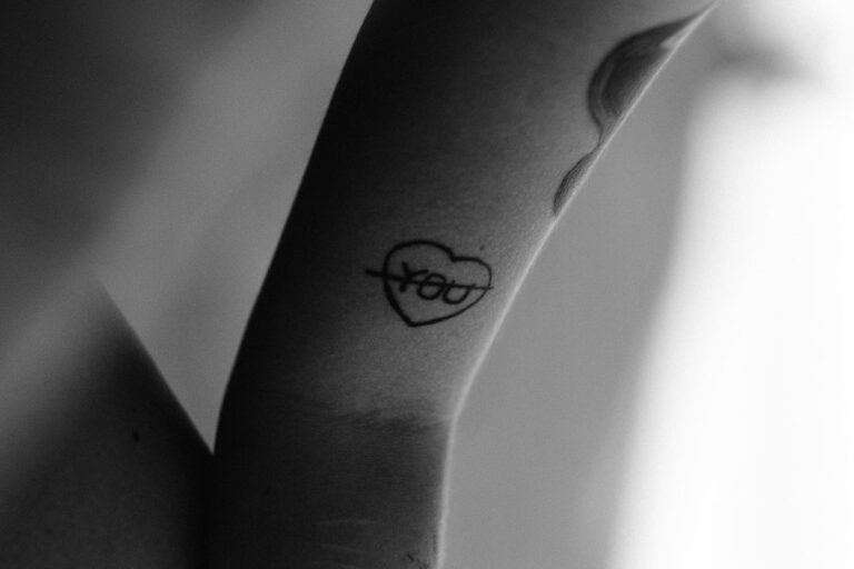black tattoo on persons arm