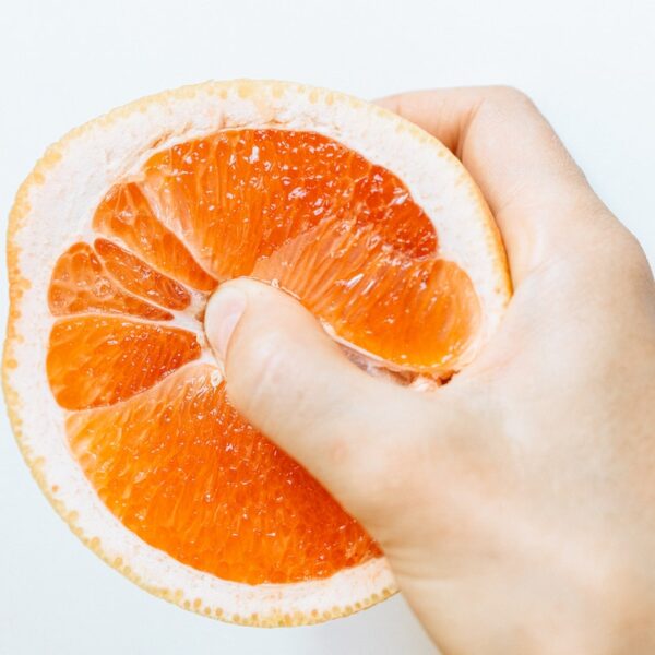 Person Holding Sliced Orange Fruit