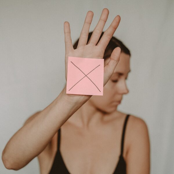 Woman with paper with cross sign