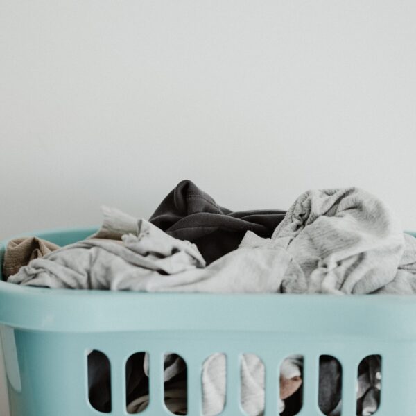 white textile on blue plastic laundry basket