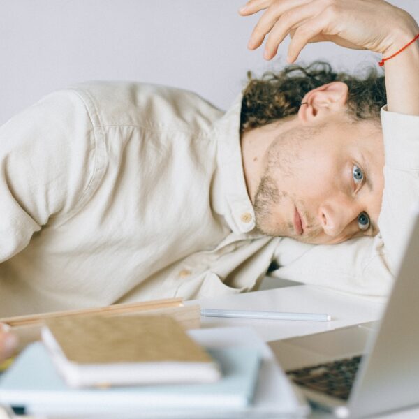 Overworked Employee lying in front of Laptop