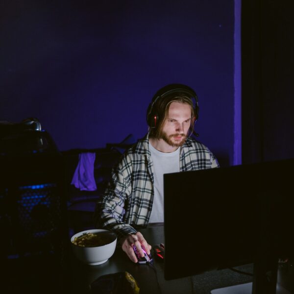 Man in Plaid Shirt Playing a Computer Video Game