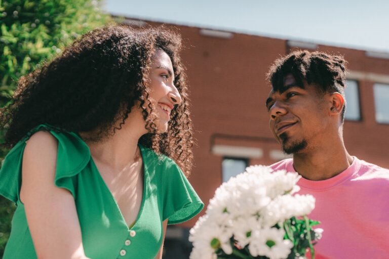 Low-Angle Shot of a Man Giving a Woman a Bouquet of Flowers