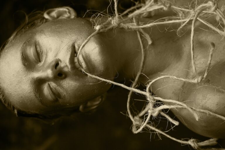 grayscale photo of woman with white flowers on her ear