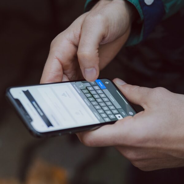 selective focus photography of person using smartphone